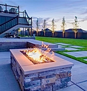Fire pit, oversized pavers and lawn in an outdoor living space
