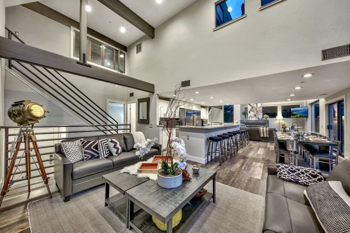 Double-height living room opening into a kitchen