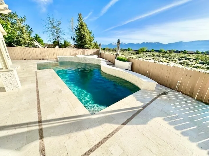Pool with a light-colored hardscape surround